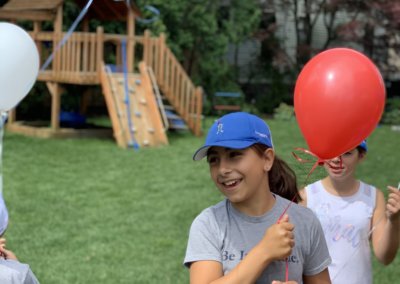 Girl with balloon at the virtual walk for Boston Children's Hospital